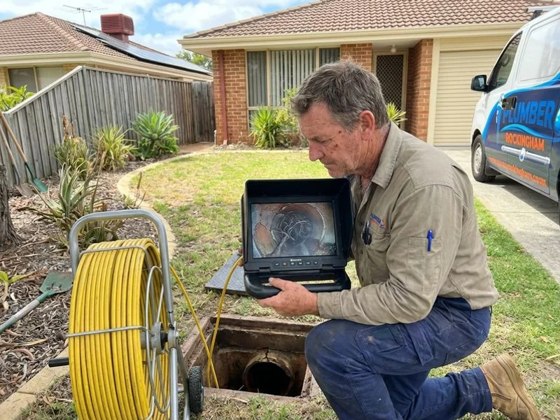 CCTV drain camera showing tree root intrusion in a clay sewer pipe
