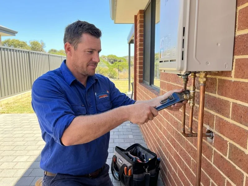 Licensed plumber repairing hot water system in a Rockingham home